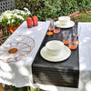 Unbreakable dinnerware, showing plates and bowl and the Marc Newson unbreakable drinkware in orange